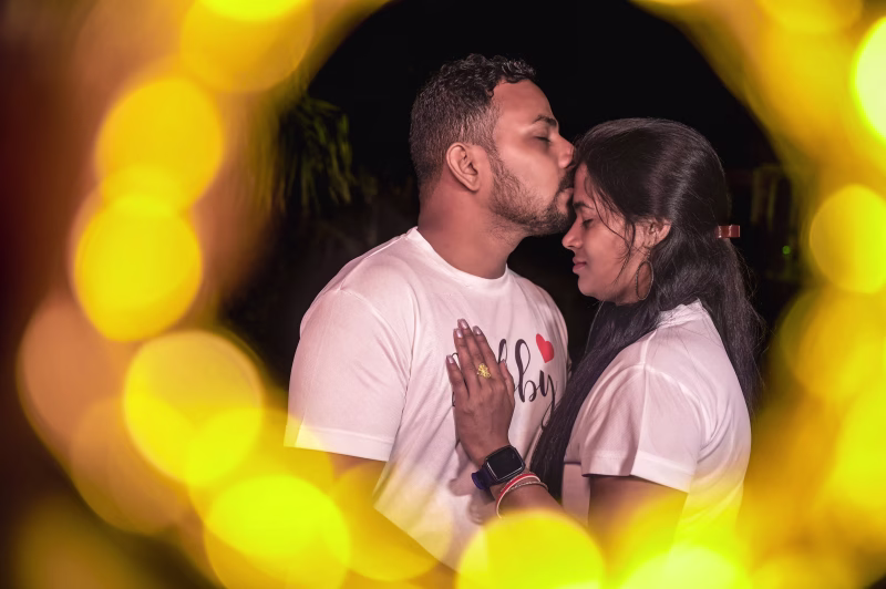 Cinematic wedding film still with golden bokeh lights by Nayak Studio